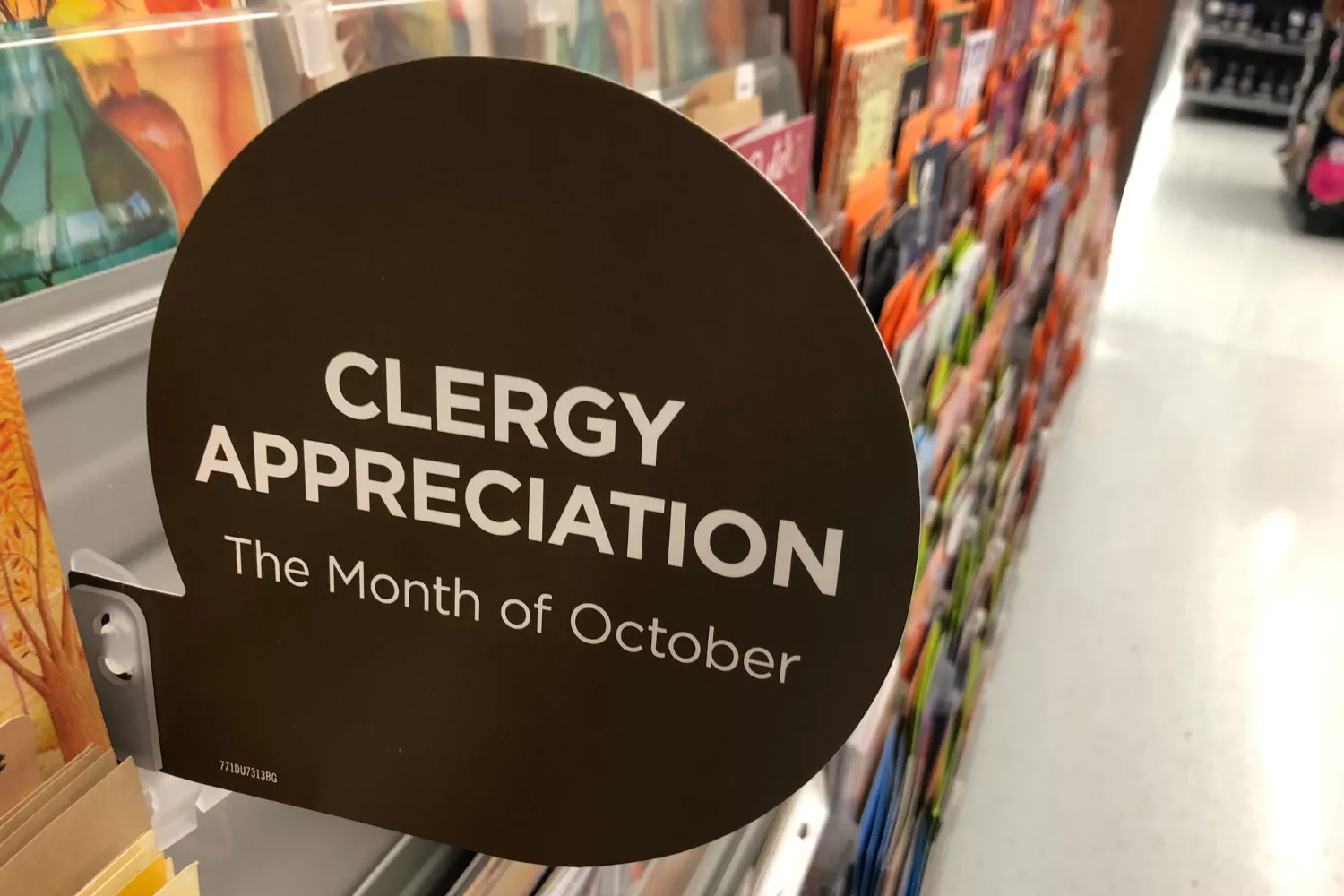 A store display sign reading “Clergy Appreciation – The Month of October,” promoting ways to honor pastors.