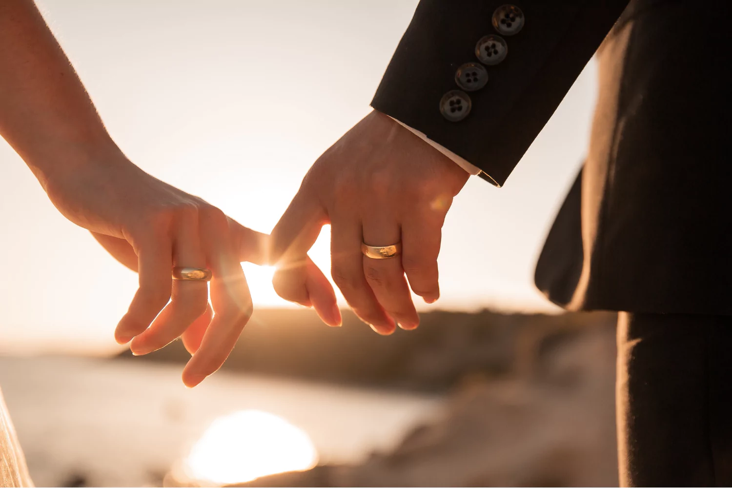 husband and wife lovingly holding hands as they commit to each other for life, depicting what Jesus said about marriage.