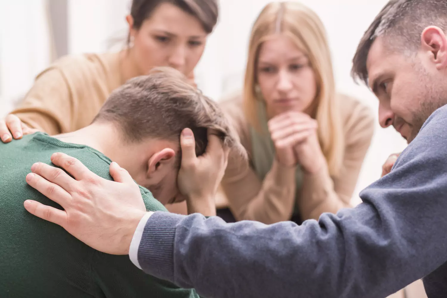 Counseling group supporting someone who is distressed