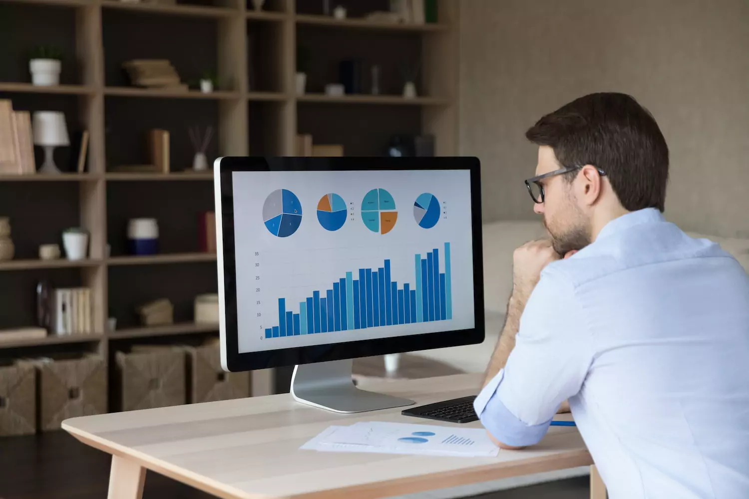 Man looking at data on a desktop
