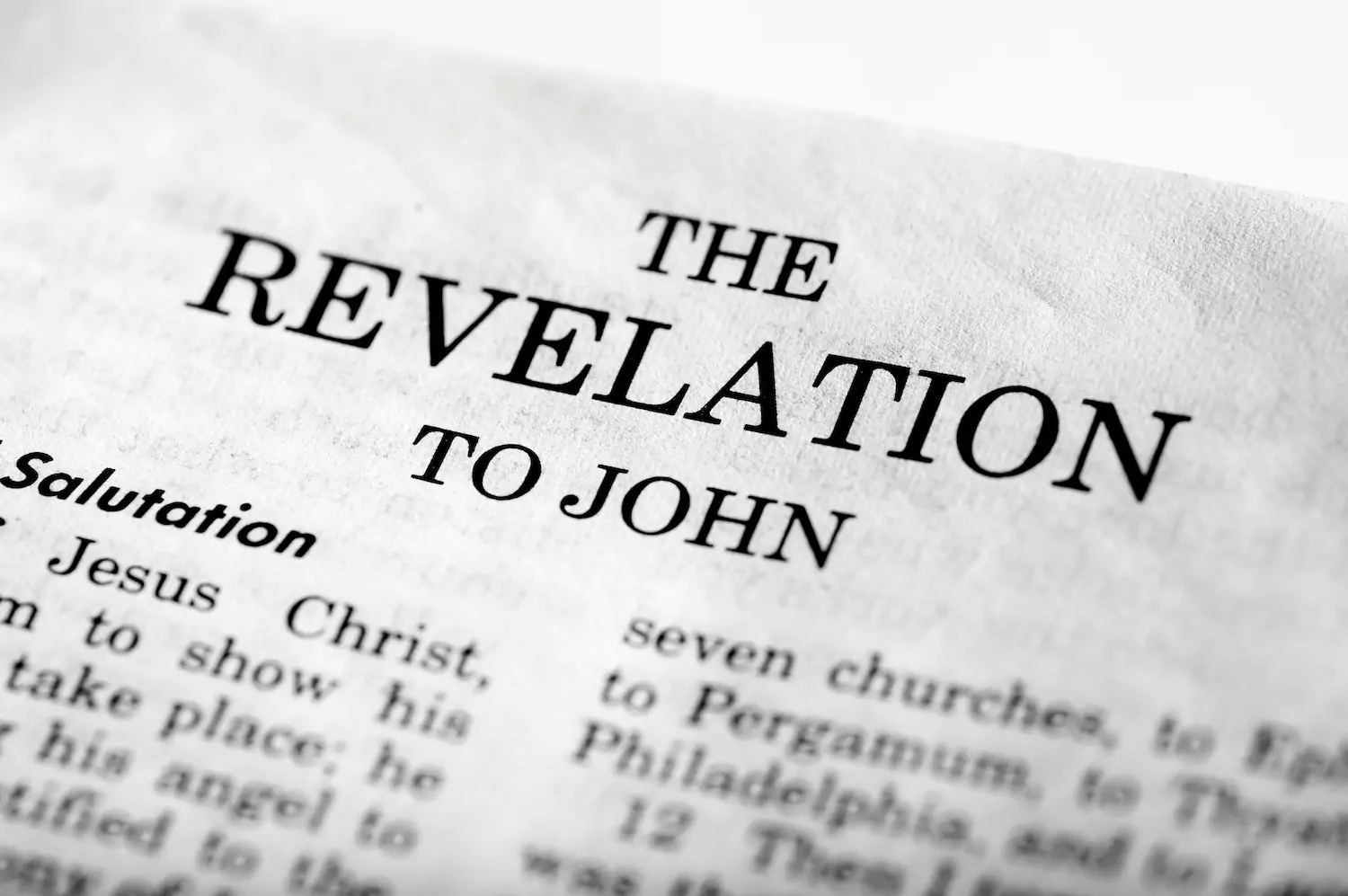 A photo of The Revelation to John from the Bible. A photo of a page in the Bible.