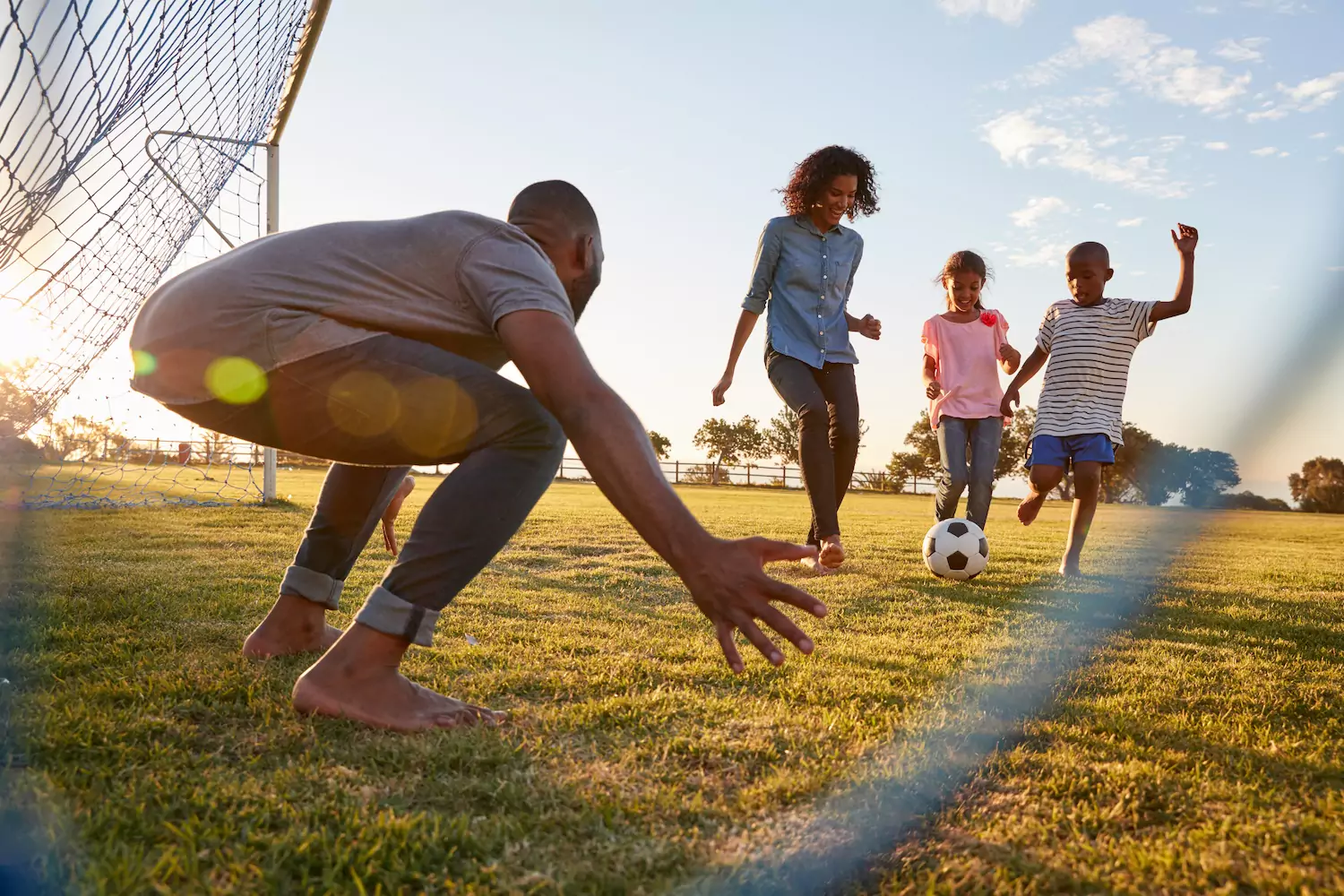 A father plays goalie in front of a soccer net, while his three kids kick the soccer ball in front of him. Your ministry time as a pastor is best used when you lead your flock in outreaches to the unsaved. Here are ten practical ways you can do that this summer.