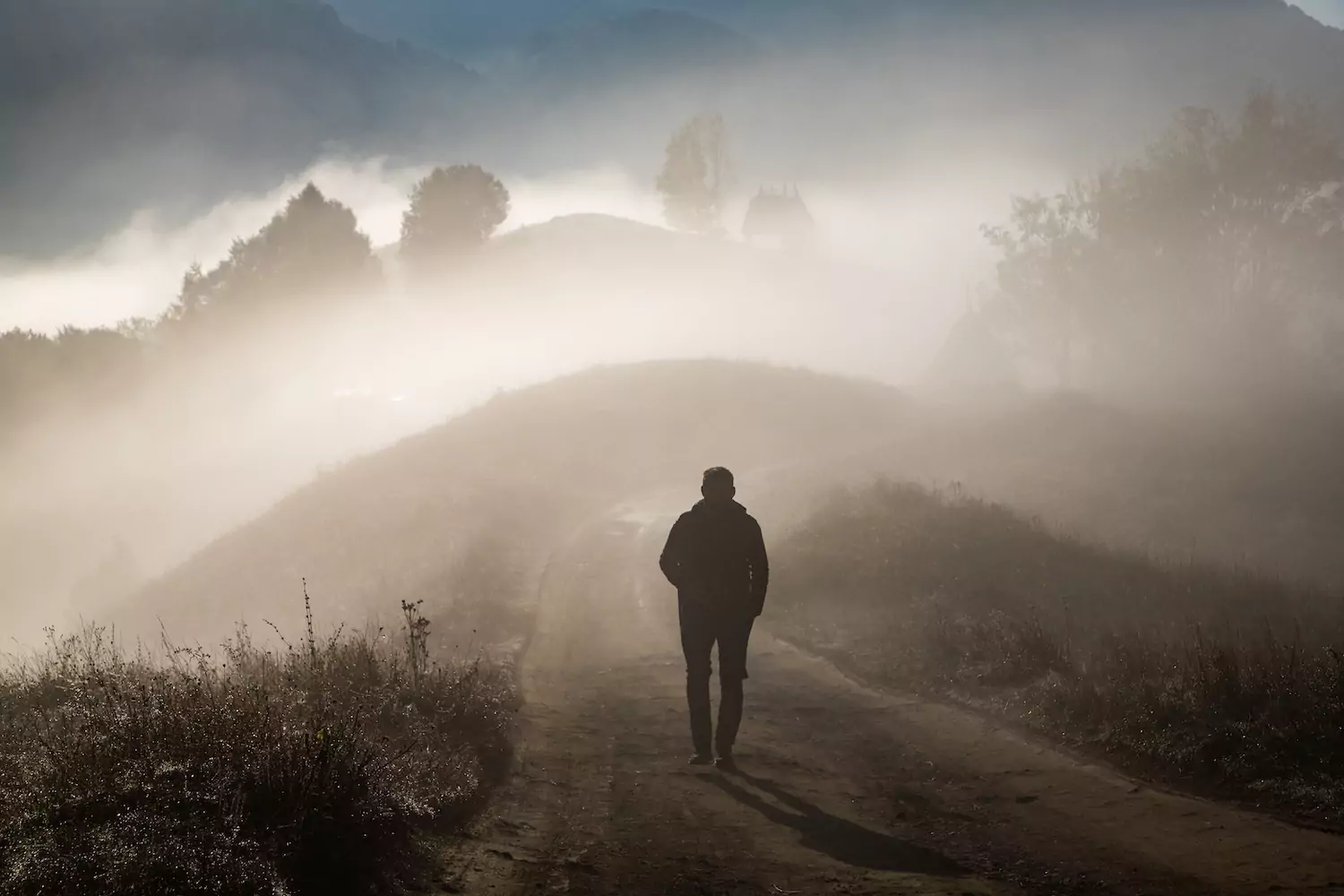 A pastor walks down a foggy dirt road contemplating the pastor's role in suicide prevention.