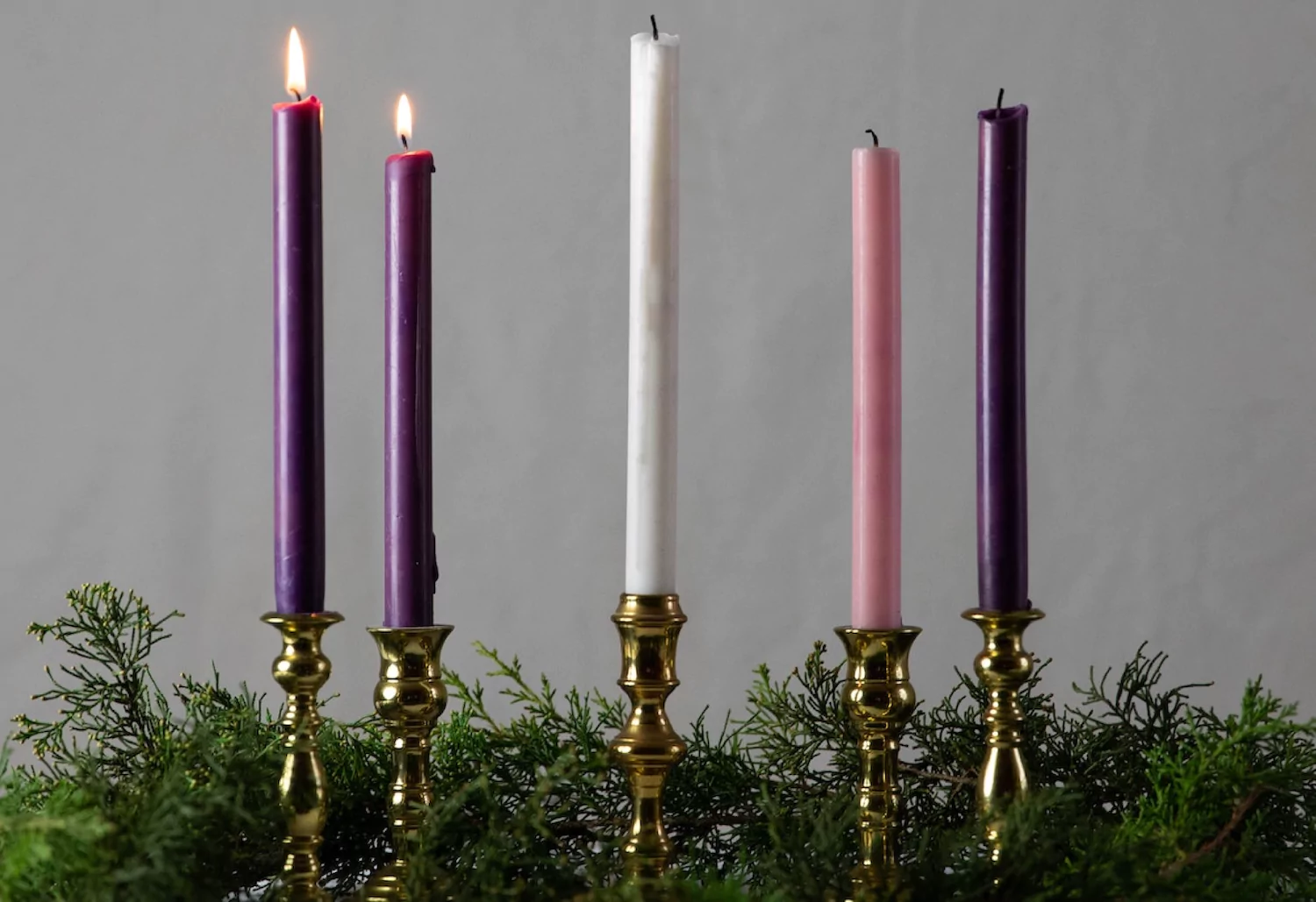 an advent wreath with traditional advent candles, two of which are lit to mark the second week of advent