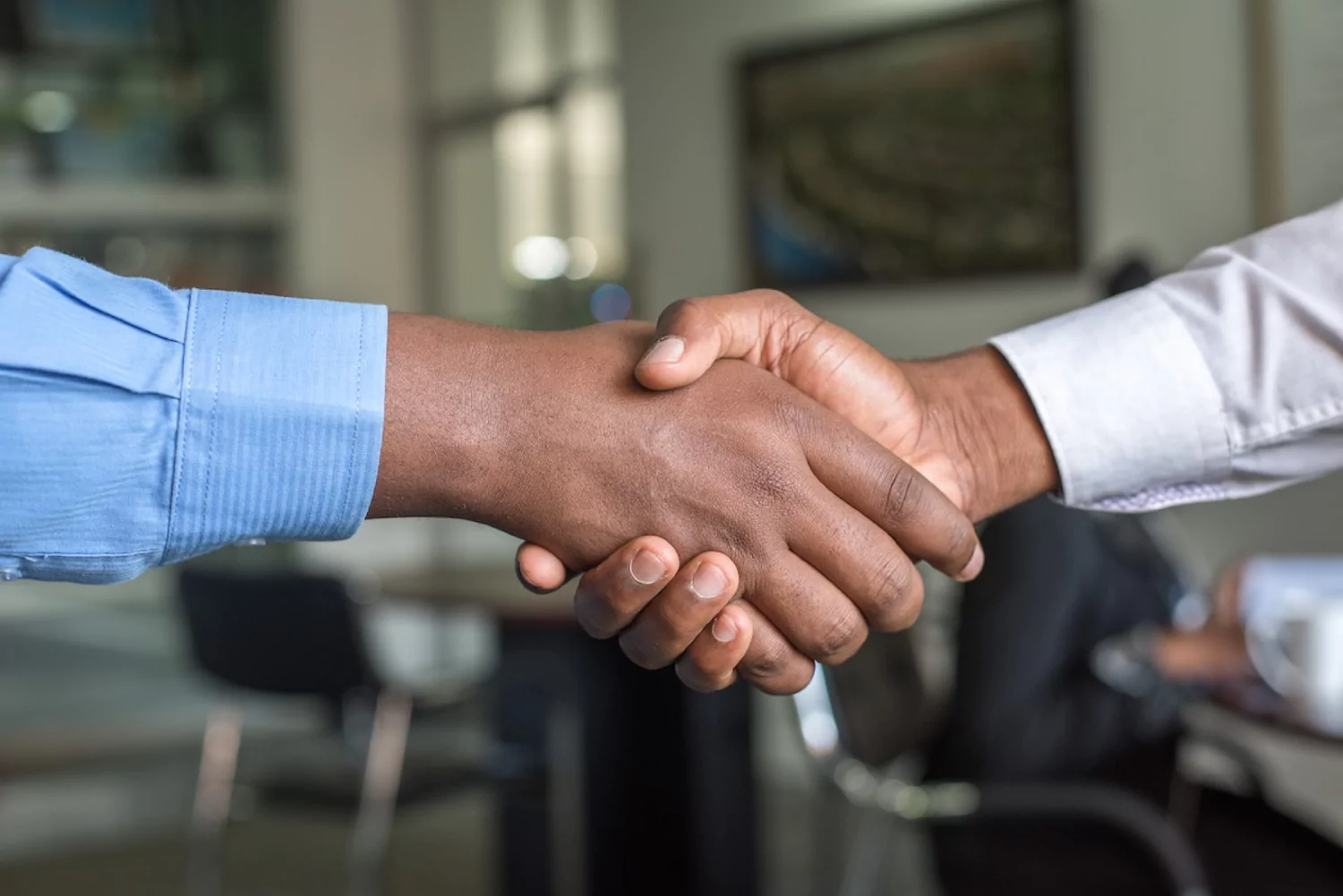 a close-up of a church leader and seminary student shaking hands