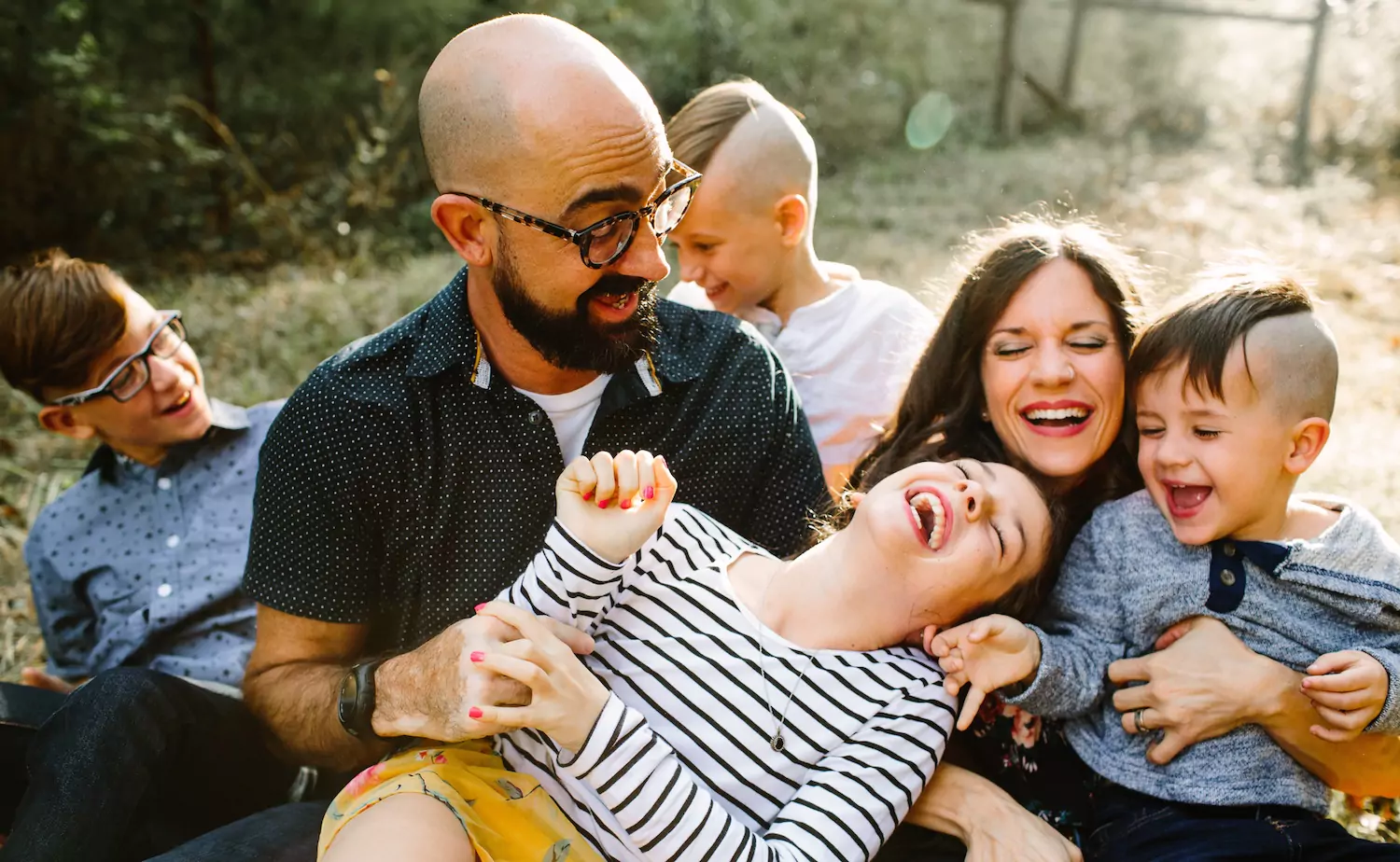 a pastor's wife and her family laugh together, helping the kids to appreciate life in ministry