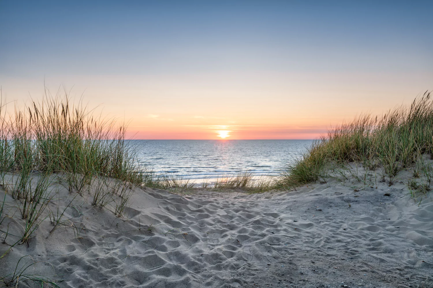 landscape shot from the shore overlooking the ocean sunset at the end of summer