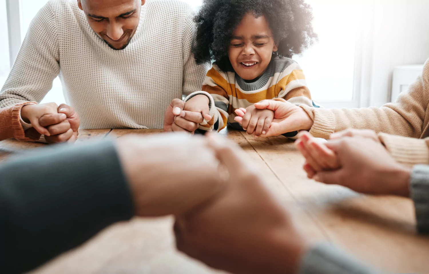 a pastor leads family devotions at the dinner table