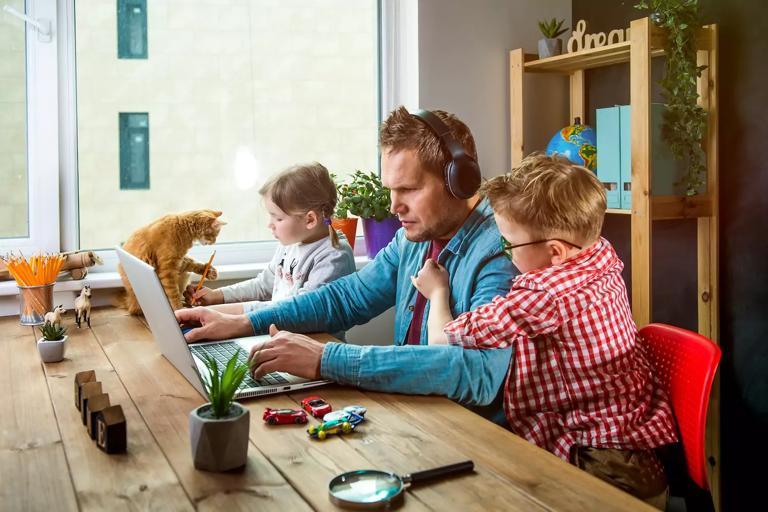 a stressed pastor dad ignores his kids as he focuses on work