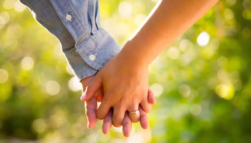 Close-up of couple holding hands
