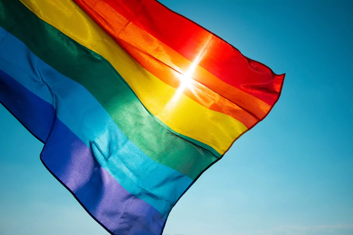 LGBT pride flag waving against a blue sky, reminding pastors they must speak the truth about sexuality and gender.