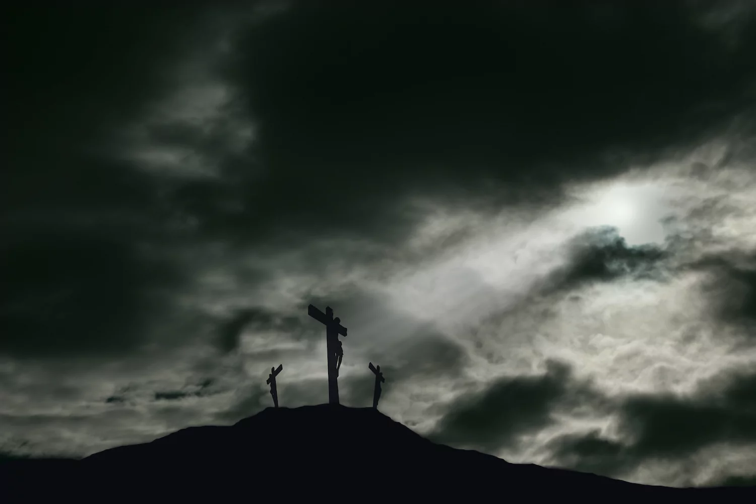 An image of Good Friday with three crosses on a hill.