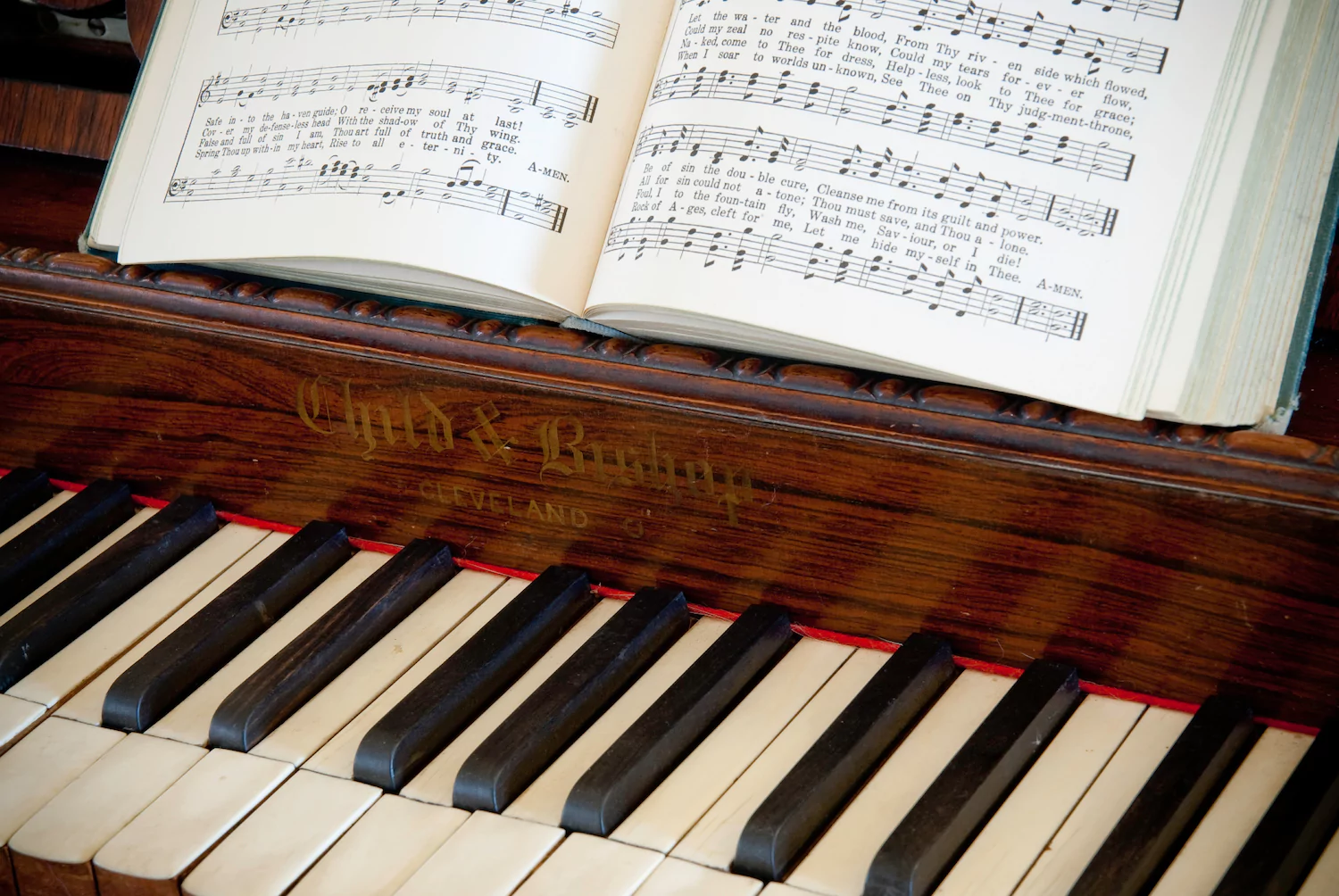 A hymnal sits on a piano.