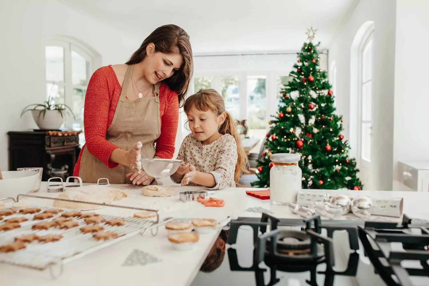 A mother bakes with her daughter during Christmas.