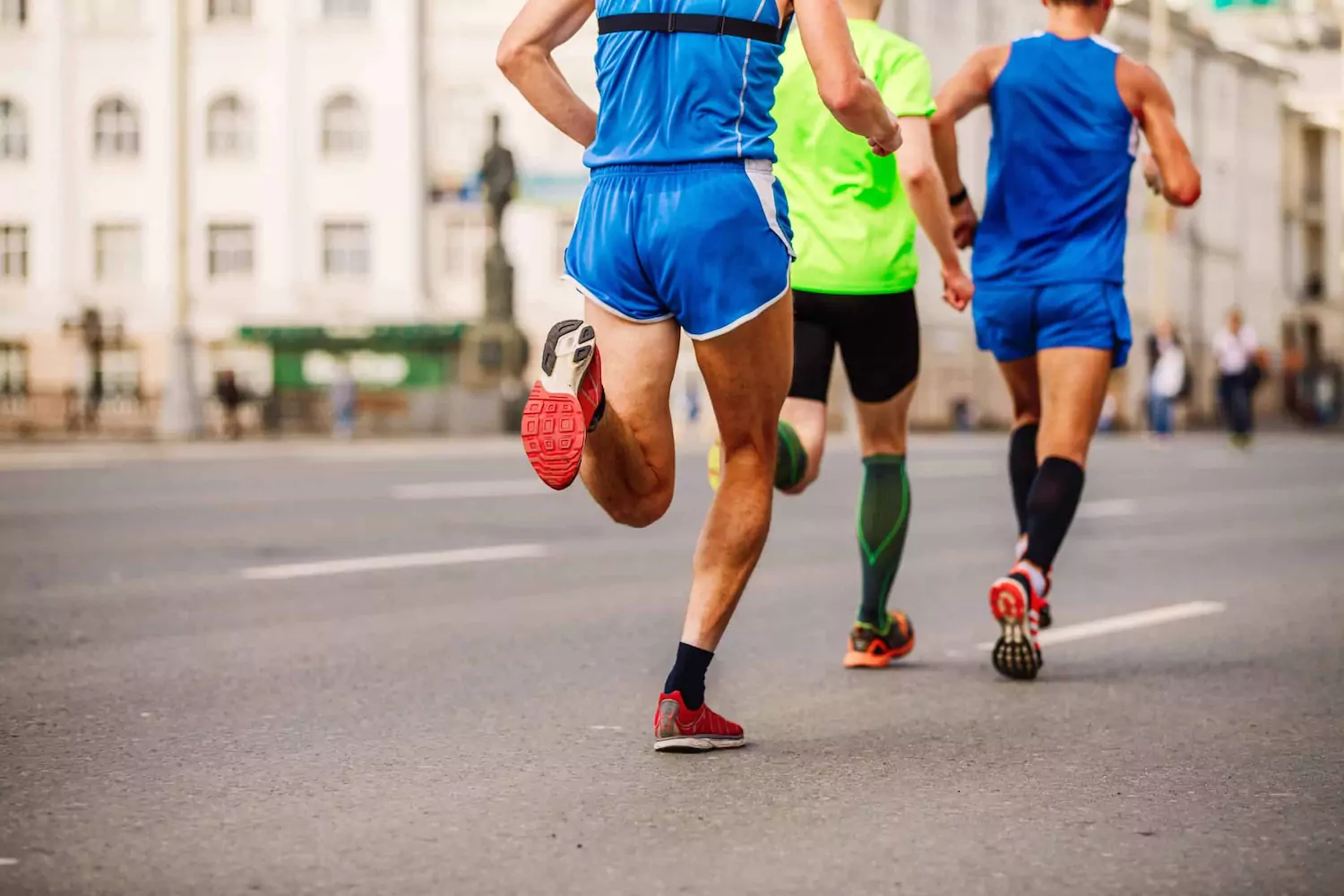 Three men run down the street in a race, representing spiritual discipline.