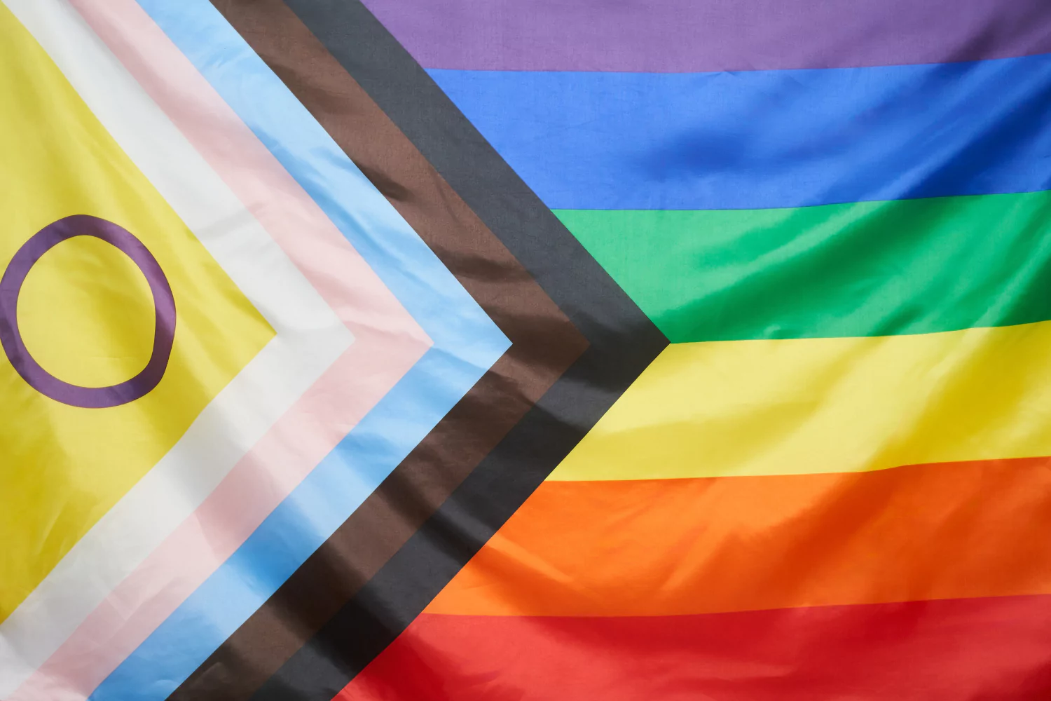 Progress Pride flag with vibrant colors symbolizing LGBTQ+ that is flown during Pride Month.