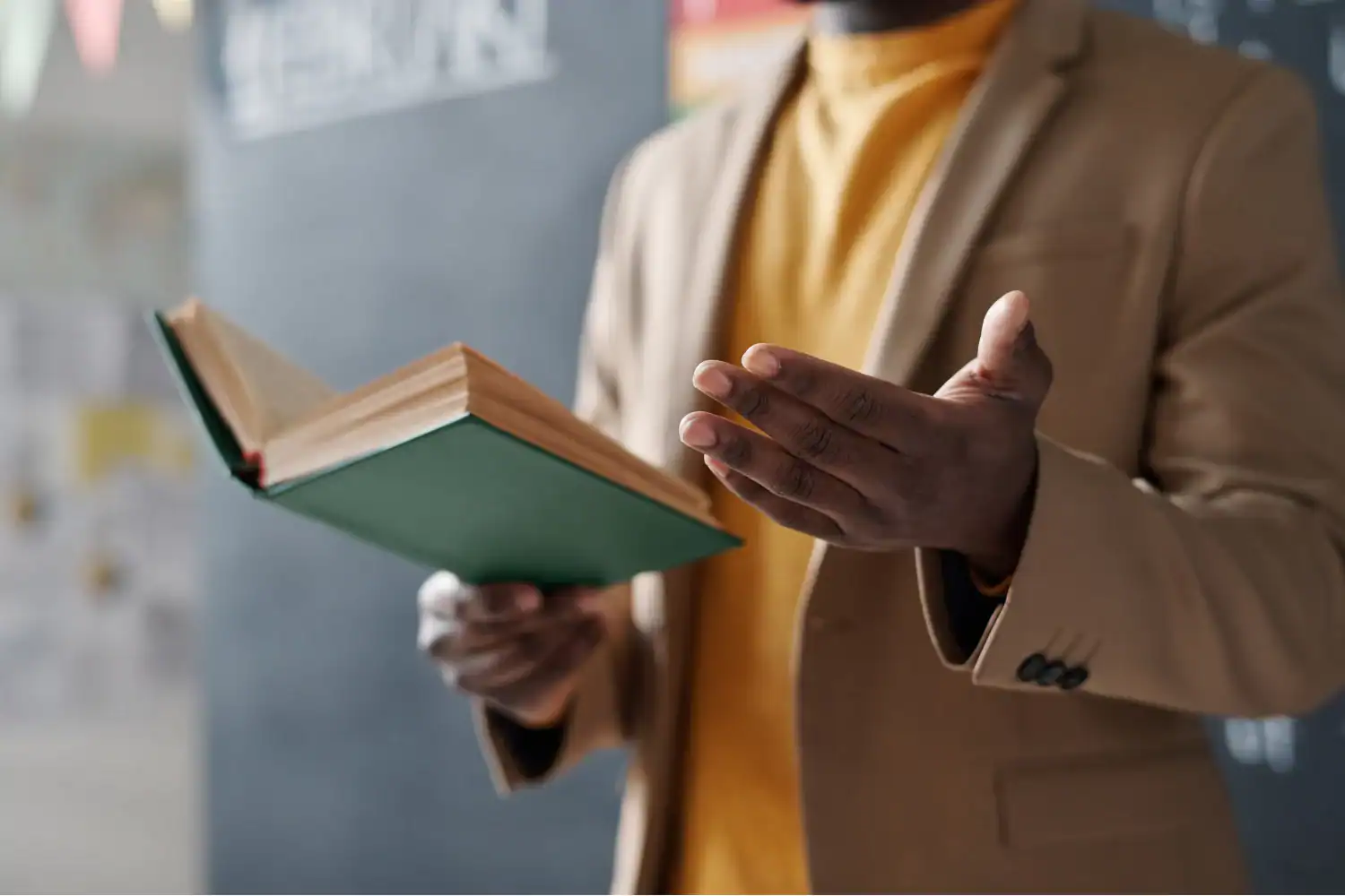 Man holding an open book and gesturing while speaking, illustrating the concept of "how to preach."